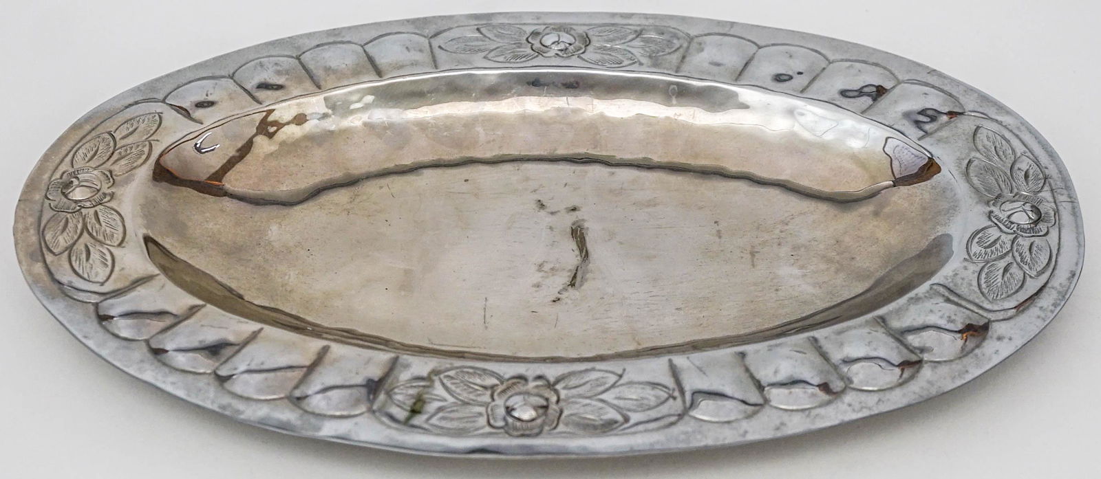 Hubert Harmon Mexico Oval Tray Silver Plate: Hubert Harmon Mexico Oval Tray Silver Plate. Signed (stamped) underside 'Hubert Harmon'. Tray measures12.125 in. x 7.9375 in. x 1 in. tall. Note light scarring center of tray. If lot is absent of a co