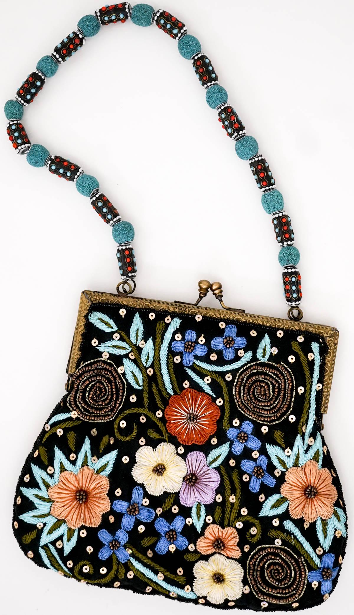 Vintage Bougainvillea Embroidered Purse: Vintage 'Bougainvillea' purse with a floral embroidery pattern and a beaded strap. Decorated with sequins and beads. Kiss lock. Measures 7 in. high (16 in. with extended strap) x 8 in. wide. If lot is