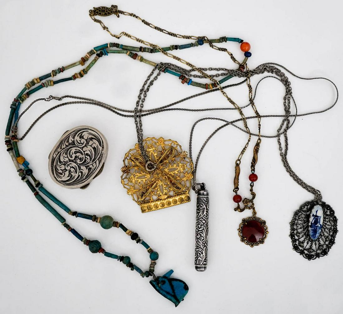 Fashion Jewelry (6) Pieces: Six (6) pieces of fashion jewelry. Includes: 1) Four (4) necklaces. Chains measure 18 in. - 29 in. 2) Brooch measures 2 in. x 2 in. 3) Pill box measures 1.75 in. x 1.3325 in. If lot is absent of a con