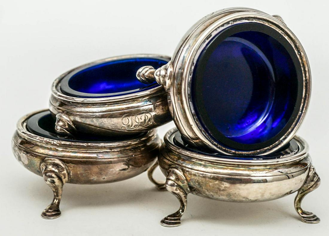 Set of (4) Sterling Salt Cellars: Set of (4) Sterling Salt Cellars. Stamped "Reproduction 1757". They have the cobalt glass liners and measure 1.25-in. x 2.625-in. Each weighs approximately 51 grams without the liners. Excellent condi
