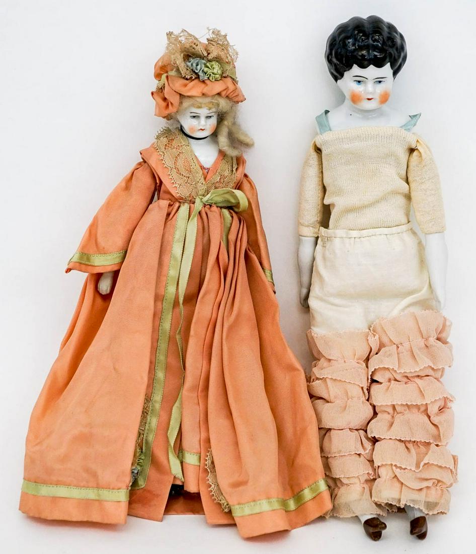 Antique (2) Porcelain Dolls [12 IN]: Two (2) antique china / porcelain dolls. The heads are porcelain, arms bisque and the smaller doll has bisque lower legs and feet, the larger is porcelain. If lot is absent of a condition report one m