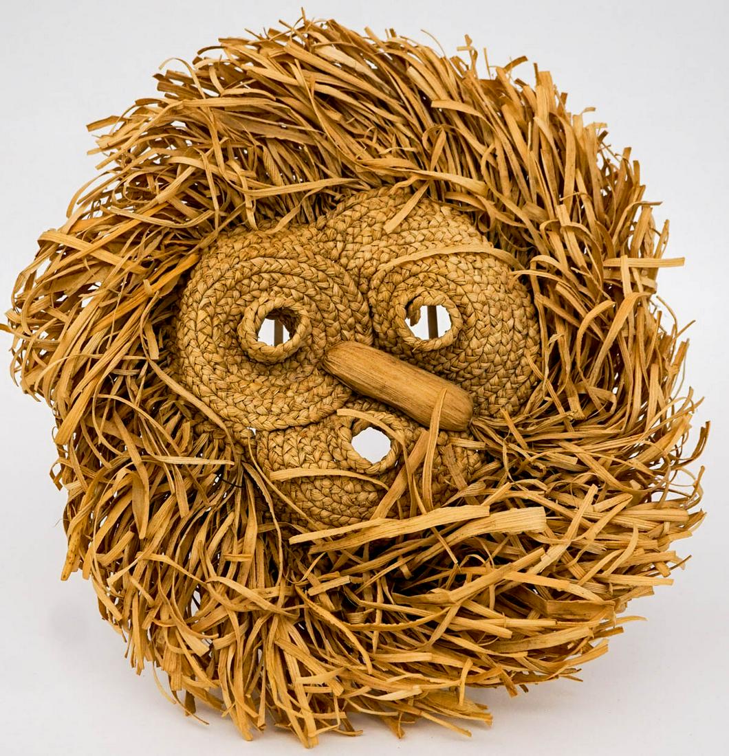 Seneca Corn Husk Mask Circa 1930: Seneca Corn Husk mask with protruding nose, mouth and eyes and fringing around perimeter of the braided face. Measures 14 in. diameter. If lot is absent of a condition report one may be requested via