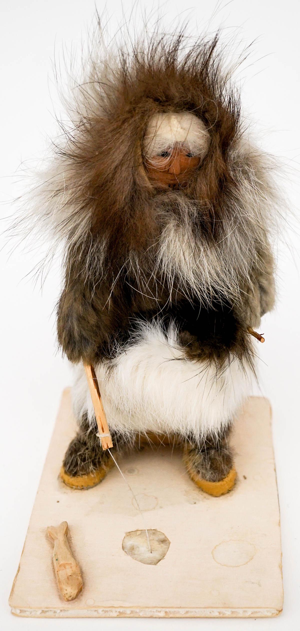 Eskimo Doll by Eva Heffle [Ice Fishing]: Eskimo doll ice fishing. Signed 'Eva Heffle, 1983' on underside. Measures 7 in. tall; and the base measures 5.125 in. x 4 in. If lot is absent of a condition report one may be requested via email. Con