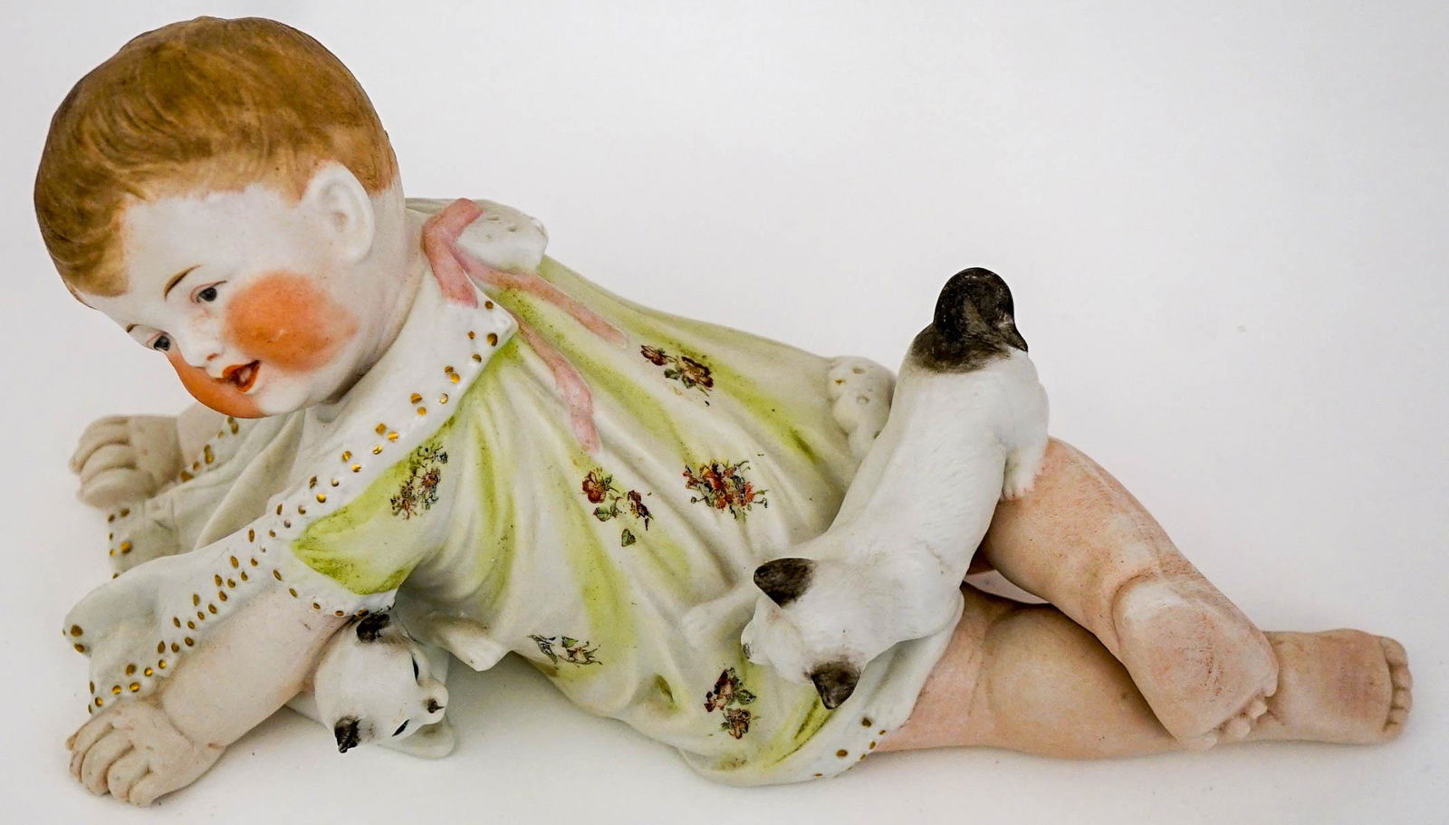 Piano Baby: An old bisque piano baby. Measures 11-in. x 5-in. x 4.25-in. No cracks, chips or repairs. Provenance: Mary Carter collection, Spokane, Wa. This item requires an outside shipper. If lot is absent of a