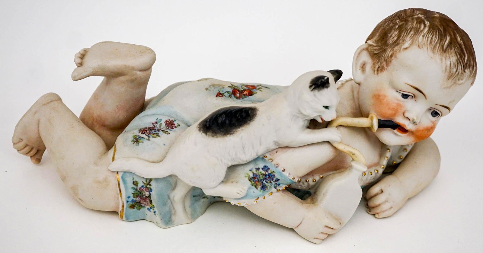 Piano Baby: An old bisque piano baby. Measures 4.25-in. x 10-in. x 3.5-in. No cracks, chips or repairs. Provenance: Mary Carter collection, Spokane, Wa. This item requires an outside shipper. If lot is absent of