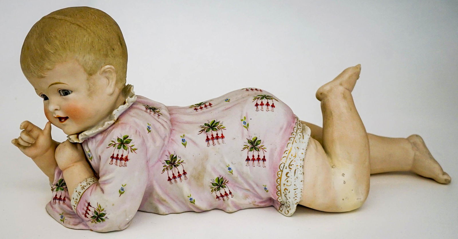 Piano Baby: An old bisque piano baby. Measures 16.5-in. x 7-in. x 5-in. No cracks, chips or repairs. Provenance: Mary Carter collection, Spokane, Wa. This item requires an outside shipper. If lot is absent of a c