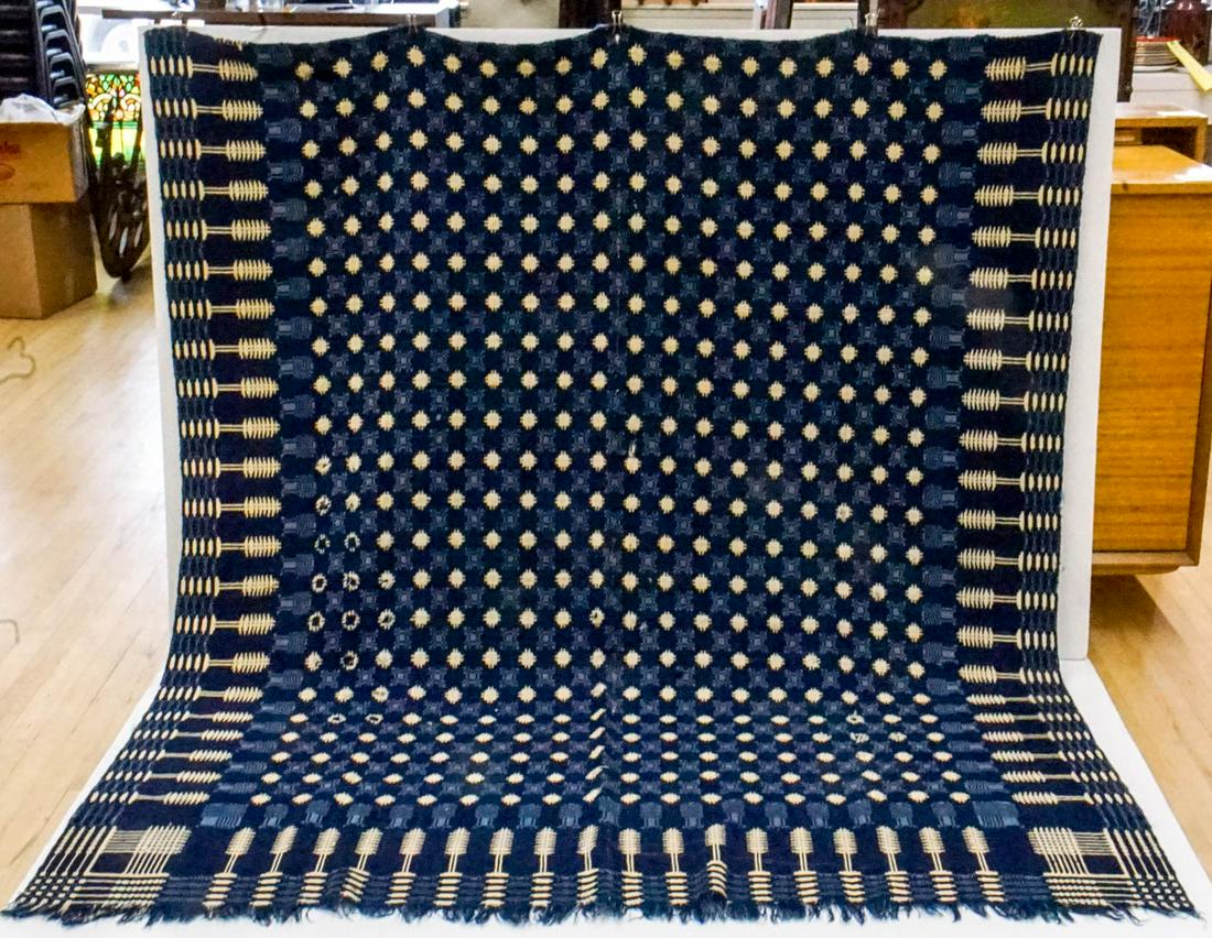 An Antique Homespun Coverlet: Measures 70-in. x 74-in. This coverlet has some repairs and spots with significant wear. If lot is absent of a condition report one may be requested via email. Condition report is provided as an opini