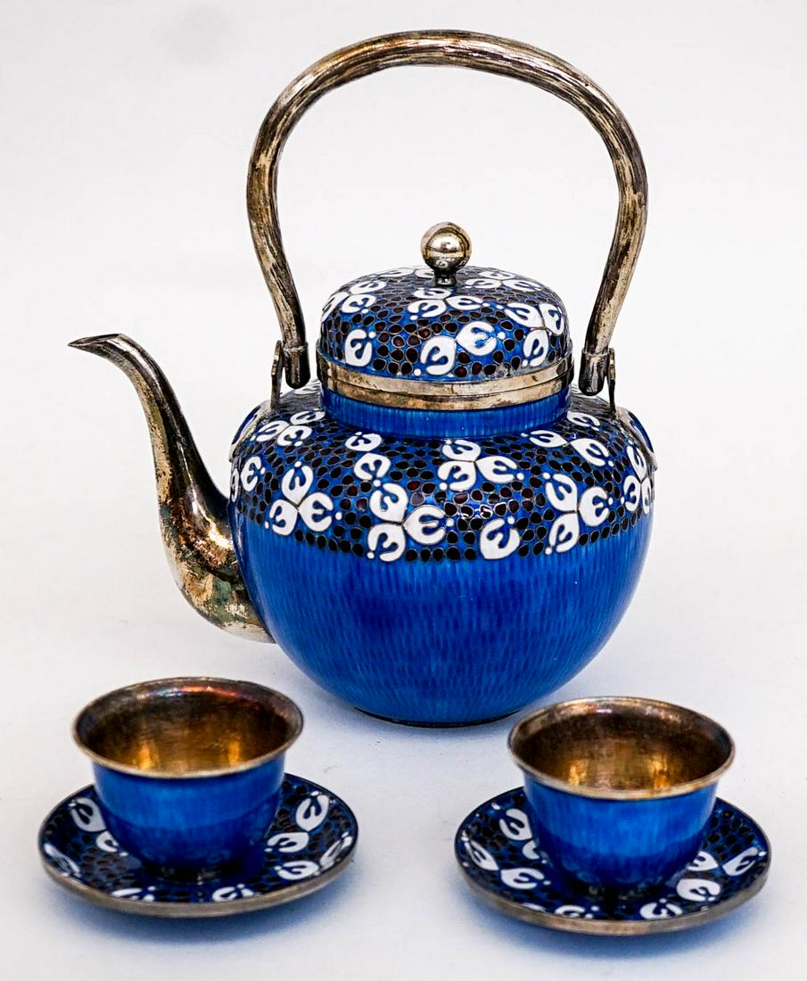 Korean Pure Silver & Enamel Tea Set: Korean Pure Silver & Enamel Tea Set. Teapot measures 7 in x 5.75 in x 4 in. Cup and saucers measure 2.75 in x 16.25 in. Total weight 583 grams. No damage. If lot is absent of a condition report one ma