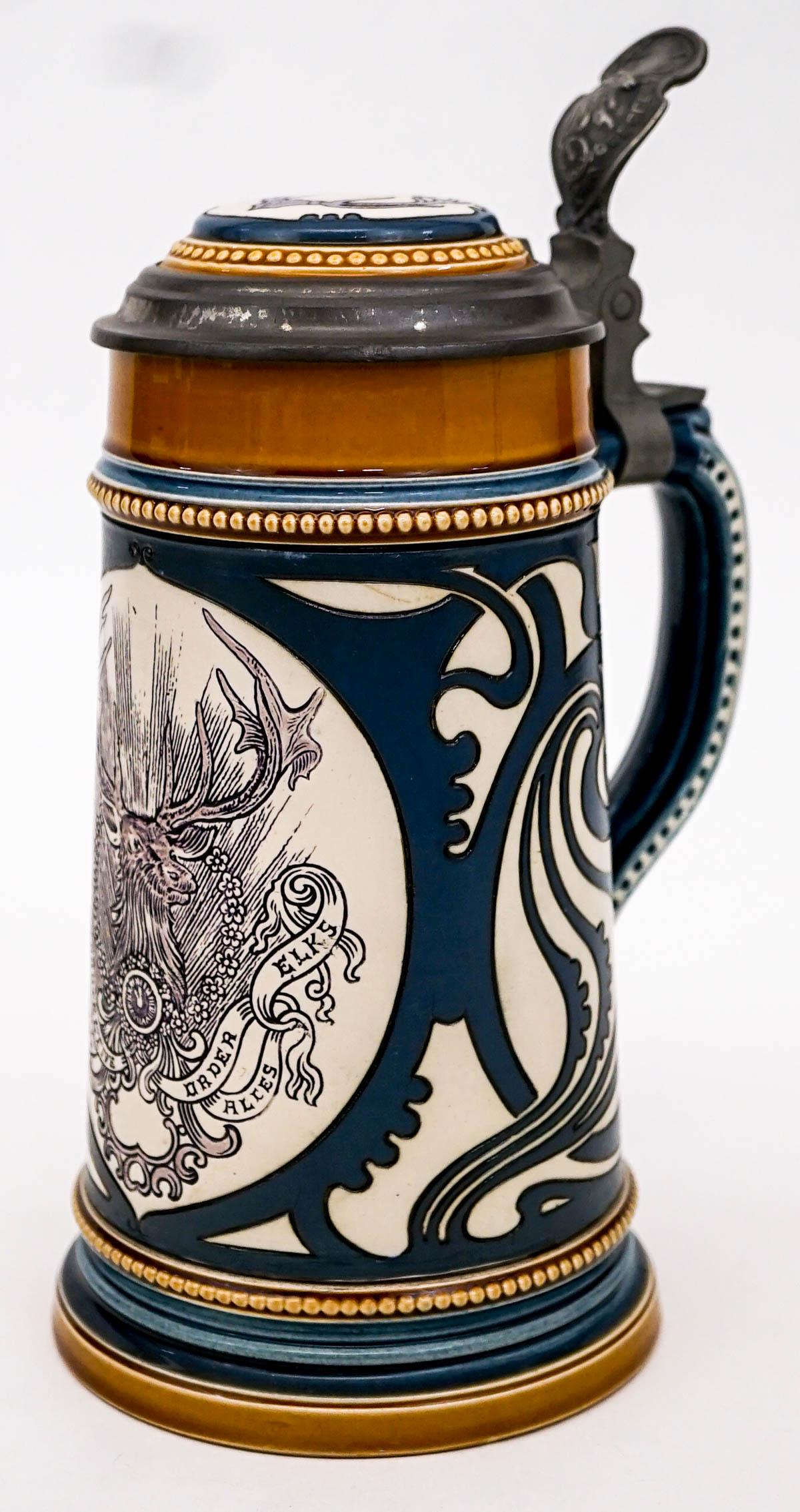 Vintage BPOE Mettlach Lidded Stein Villeroy Boch: Vintage BPOE Mettlach 2936 lidded stein / mug with pewter lid. Villeroy and Boch. Made in Germany. Measures 8.25 in. tall and 9.25 in. tall to tip of handle x 5.25 in. wide and 4.5 in. across base. We