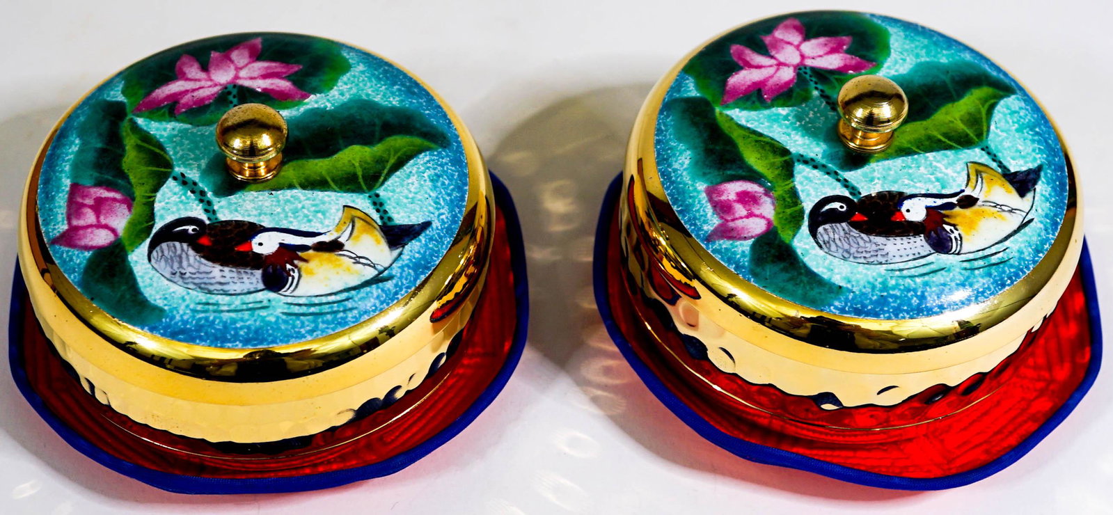 A Pair of Korean 24k Gold Plated Covered Boxes: A Pair of Korean 24k Gold Plated and Enamel Covered Boxes. Mint in box. They measure 2.25 inches x 3.25 inches. If lot is absent of a condition report one may be requested via email. Condition report 