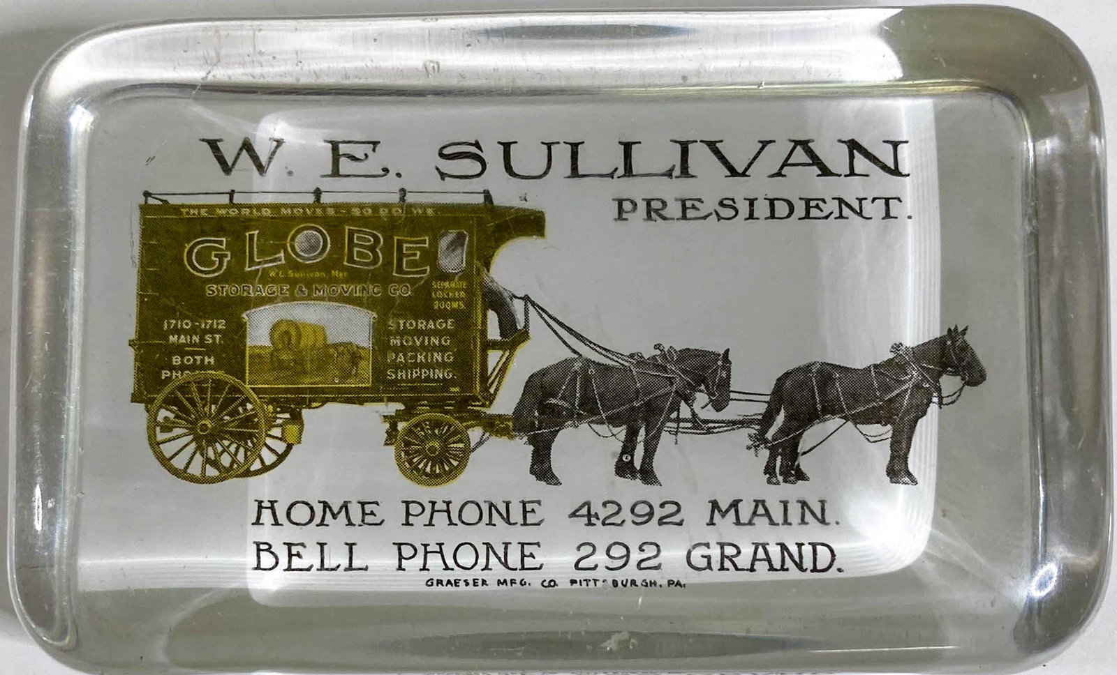 Globe Storage & Moving Glass Paperweight: [Transportation, Moving & Storage] Globe Storage & Moving Advertising Glass Paperweight by Graeser Mfg. Co., Pittsburgh, Pennsylvania. Measures .875 x 4 x 2.625 inches. Good to very good condition wit
