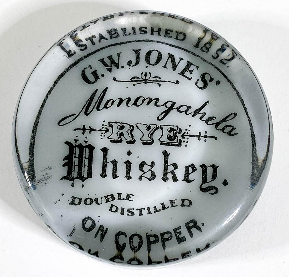 G.W. Jones Monongahela Rye Whiskey: [Whiskey, Liquor, Distillery] G.W. Jones Monongahela Rye Whiskey Antique Advertising Glass Paperweight. Measures 1 x 3 inches. Excellent condition. Provenance: Private collection Washington state. If 