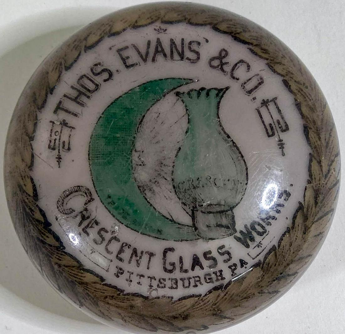 [W.H. Maxwell] Thos. Evans Crescent Glass Works: [W.H. Maxwell] Thos. Evans Crescent Glass Works Antique Advertising Glass Paperweight by W.H. Maxwell. Measures 1.75 x 3.25 inches. Fair to good condition with scratches and a few nicks. Provenance: P
