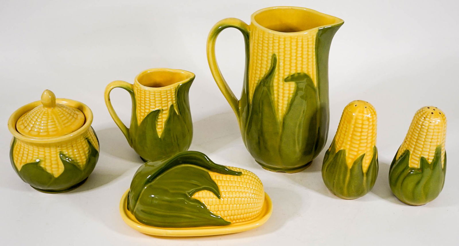 Shawnee (8 PC) Pottery King Corn Serveware: Eight (8) pc vintage Shawnee pottery King Corn serveware. Includes: 8.25 in. tall water pitcher, 5.25 in. tall salt and pepper, 4.75 in. tall creamer, 5.25 in. tall covered sugar, and covered butter d