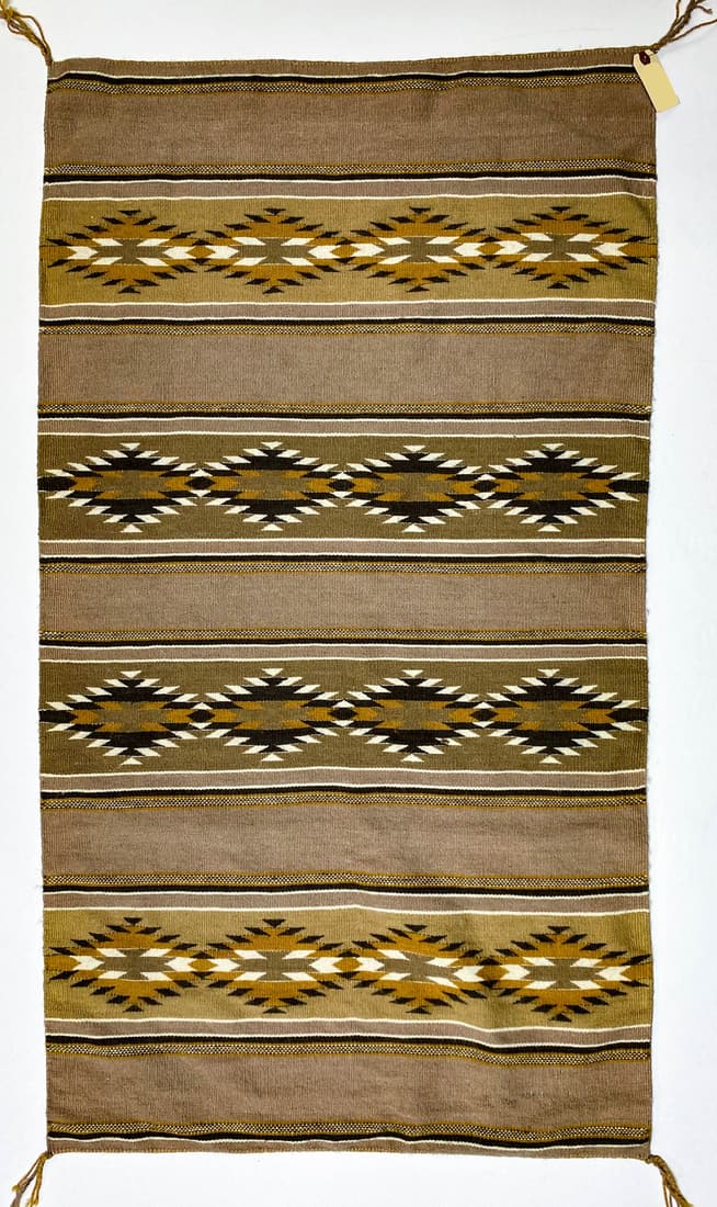 Navajo Wide Ruins Weaving/Rug 49 x 28: Navajo Wide Ruins weaving/rug (Marjorie Spencer, weaver, appraised May 13, 1970 by Packard's Chaparral Trading Co., Santa Fe, New Mexico) measures 49 in. x 28 in. with colors of browns, gold and cream