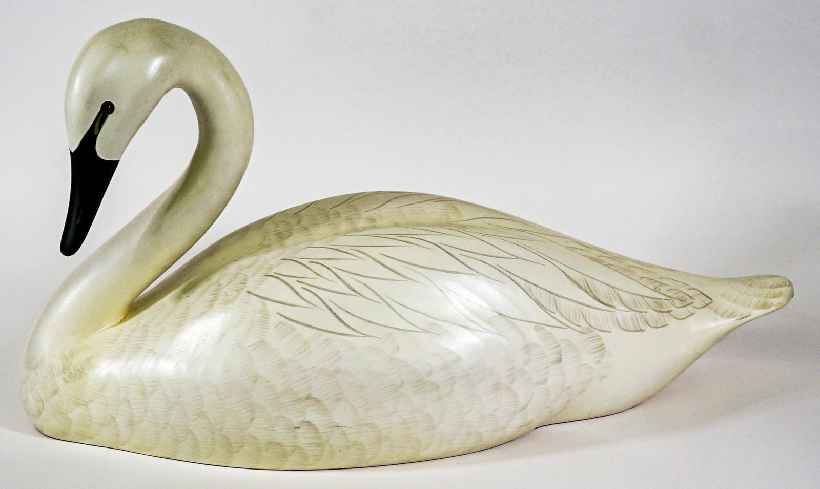 Lac La Croix Swan Decoy [Robert Capriola]: Lac La Croix Swan decoy. Special Edition Ducks Unlimited 1988-89 medallion on bottom. Artist signed and numbered 1924 on underside. Measures 22 in. long x 11 in. tall. If lot is absent of a condition 