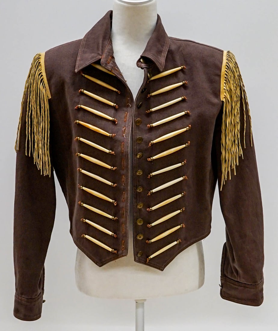 Double D Ranch Wear Jacket [Small]: Western Double D Ranch Wear jacket size marked 'small'. Short brown canvas jacket with fringe at shoulders and beaded with faux-bone on front. Measures 17 in. across shoulders; 18 in. from nape of nec