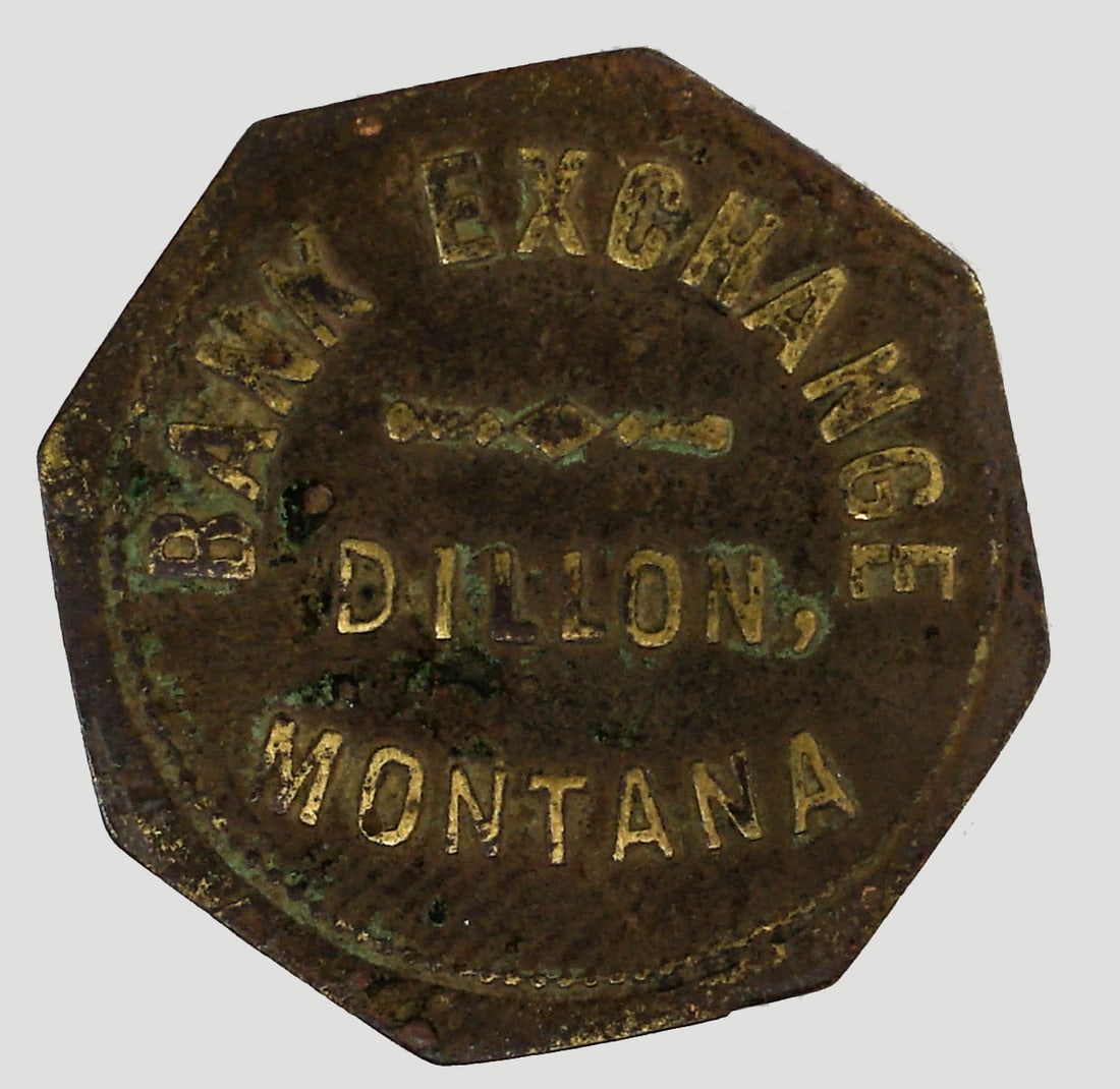 Bank Exchange (Dillon, Montana) Token: Bank Exchange (Dillon, Montana) Token. Measures 25 mm. Provenance: Montana private collection. If lot is absent of a condition report one may be requested via email. Condition report is provided as an