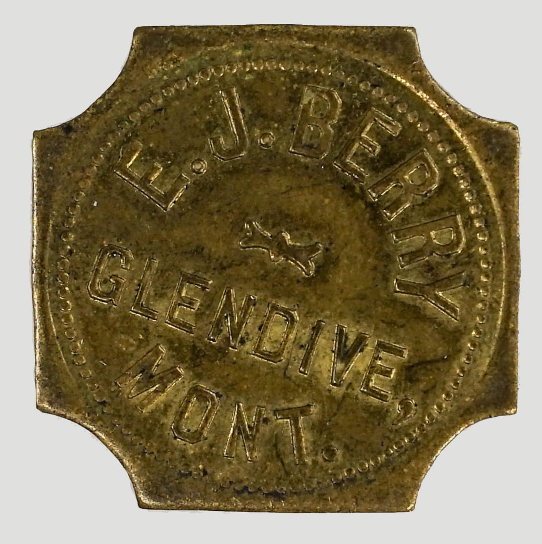 E.J. Berry (Glendive, Montana) Unlisted Token: E.J. Berry (Glendive, Montana) Unlisted Token. Measures 24 mm. Provenance: Montana private collection. If lot is absent of a condition report one may be requested via email. Condition report is provid
