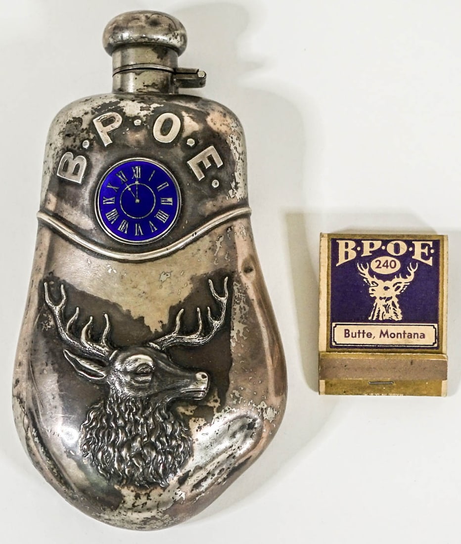 Butte, Montana Elks (B.P.O.E) Sterling Flask: Butte, Montana Elks (B.P.O.E) Sterling Flask and Matchbook. The flask measures 6 inches. Flask has some dents. Provenance: Montana private collection. If lot is absent of a condition report one may be