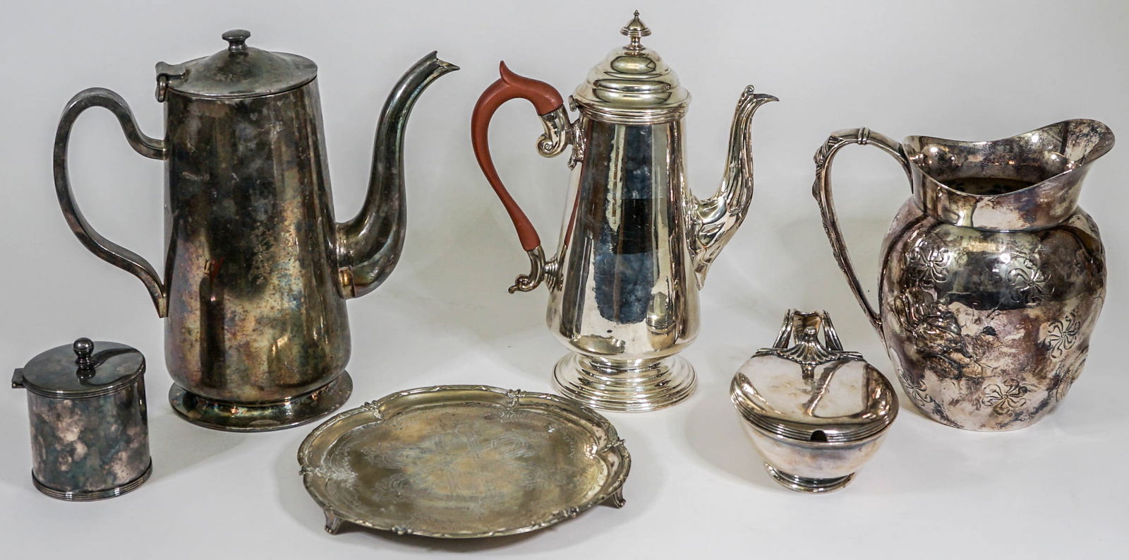 Serveware (6) Silverplate Pieces: Six (6) pieces of serveware. Includes: Pair Pointe Quadruple Plate water pitcher, DW Haber and Son coffee server, and more. Provenance: Estate of David Milot. David was a Real Estate Broker by trade a