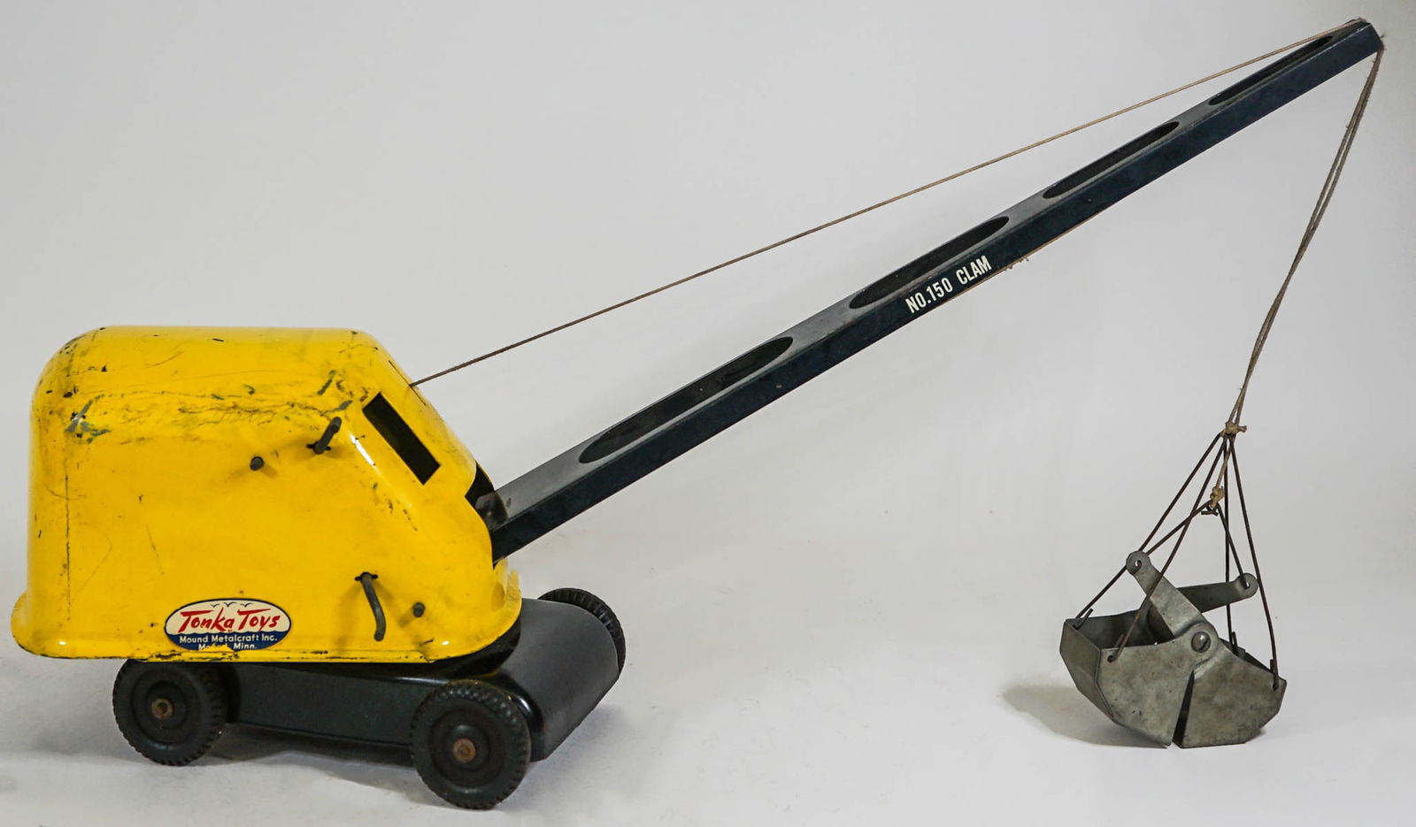 Tonka Toys Clam Bucket Crane No. 150: Tonka Toys Mound Metalcraft No. 150 clam bucket crane as positioned measures approximately 24 in. long x 12 in. high x 5 in. wide. If lot is absent of a condition report one may be requested via email