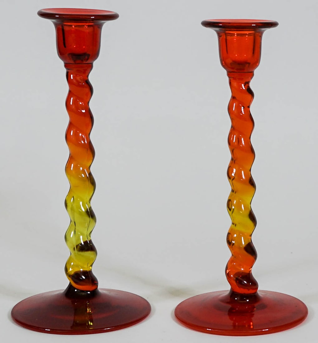 Blenko Art Glass 8.75 IN (2) Candleholders: Pair of Blenko 'Amberina' art glass candle holders measure 8.75 in. tall x 4 in. diameter across base. No evidence of chips or repair. Provenance: Montana private collection. If lot is absent of a con