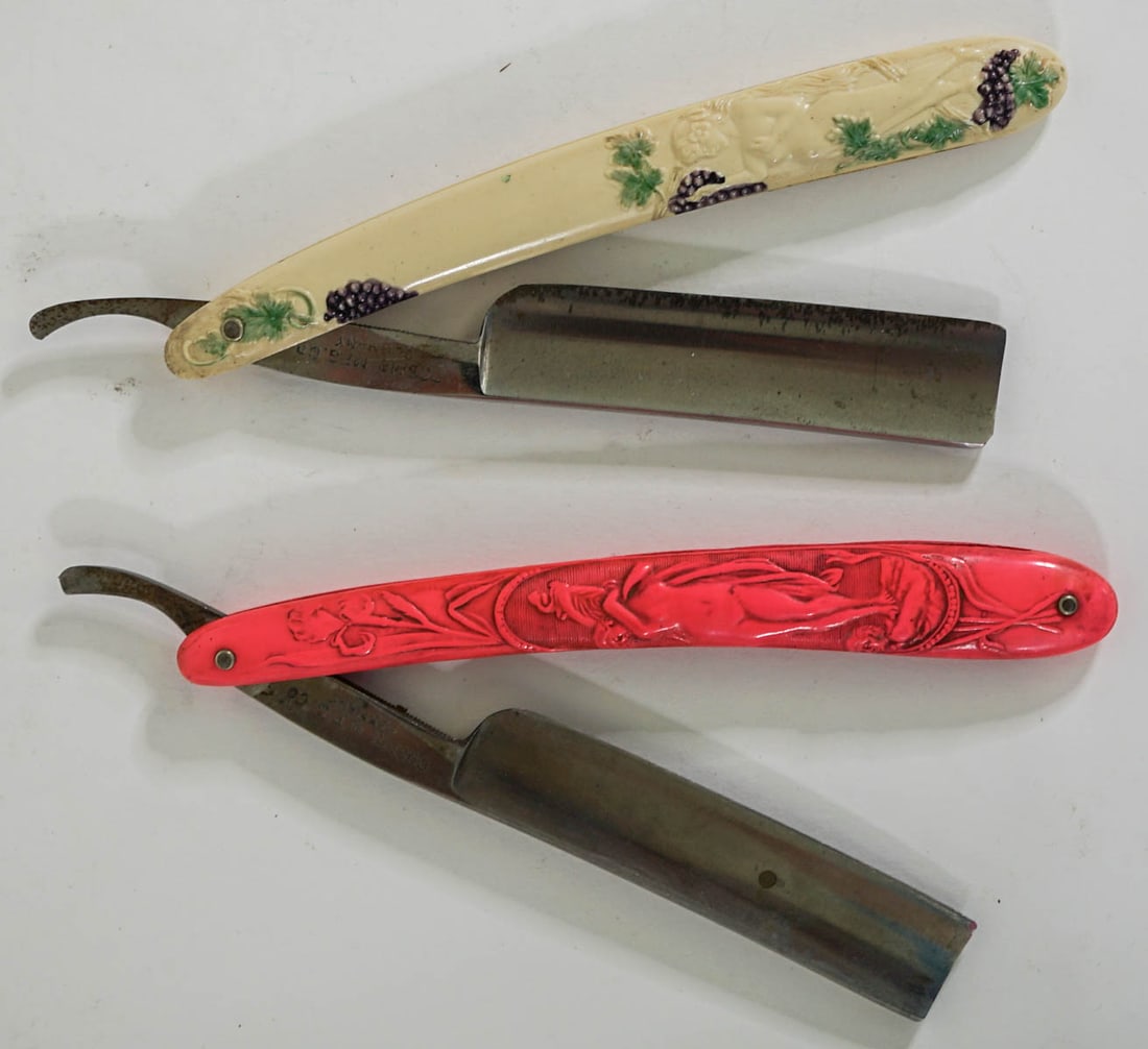 Art Deco (2) Woman Nude Straight Razors [Cosmo]: Two (2) Cosmo Mfg, Co., Germany straight razors measure 6 in. Provenance: Montana private collection. If lot is absent of a condition report one may be requested via email. Condition report is provide