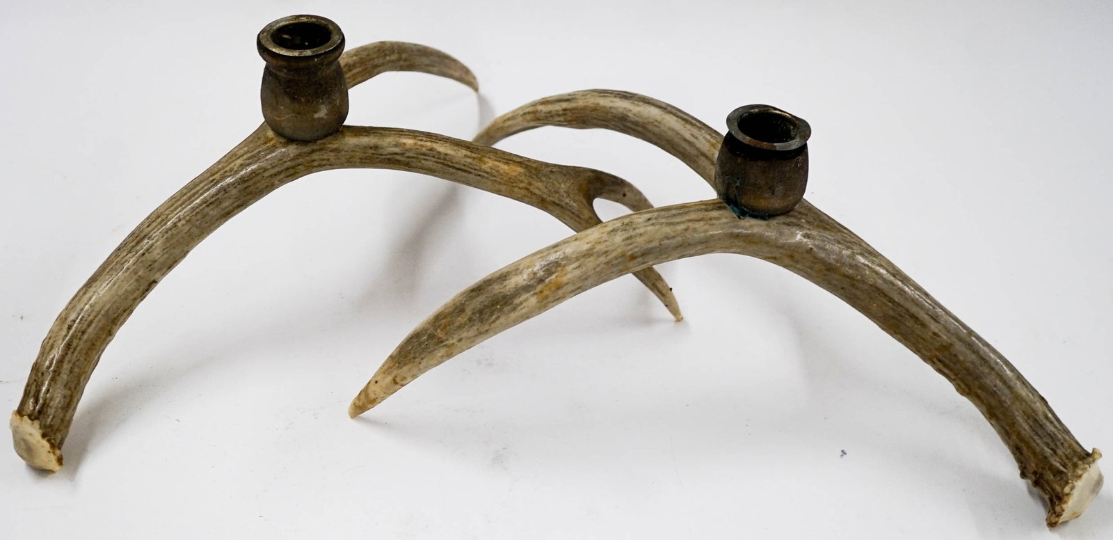 Pair of Antler Candleholders: Pair of Antler Candleholders. If lot is absent of a condition report one may be requested via email. Condition report is provided as an opinion only and is no guarantee as condition can be subjective.
