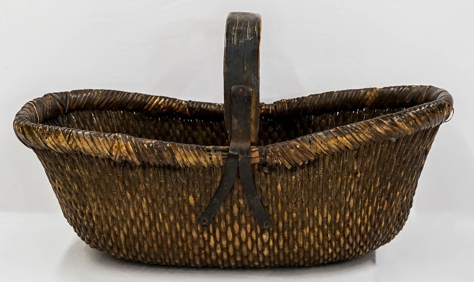 Antique West African Handled Baske: Antique West African Handled Basket. Measures 14 x 24 x 12 inches. If lot is absent of a condition report one may be requested via email. Condition report is provided as an opinion only and is no guar