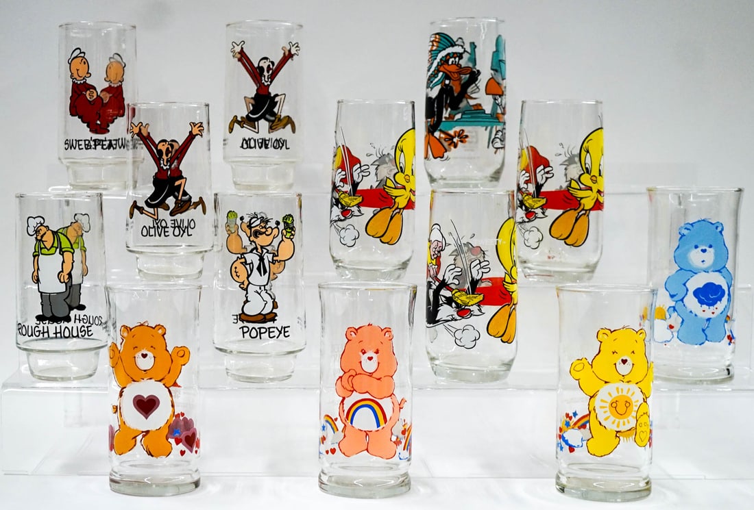 Care Bears (4), Looney Tunes (4), King Features 5: [Character Glasses] 1983 Care Bears Pizza Hut Glasses (4), 1979 Pepsi Looney Tunes (4), and 1975 Coca-Cola King Features (5). No cracks, chips or damage. The glasses are 6 inches tall. If lot is absen