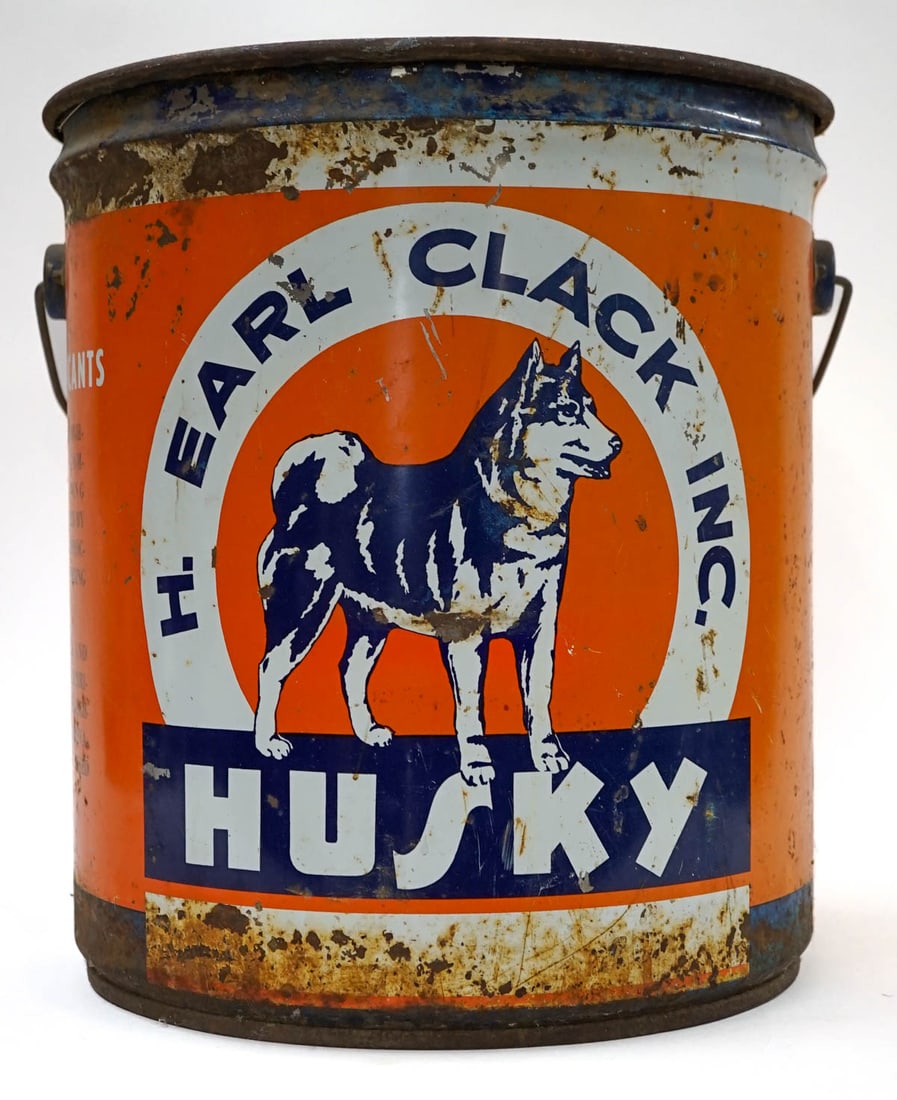 Earl Clack's Husky Oil Large Can: Earl Clack's Husky Oil Large Can. Measures 13 x 12 inches. F-G/G. If lot is absent of a condition report one may be requested via email. Condition report is provided as an opinion only and is no guara