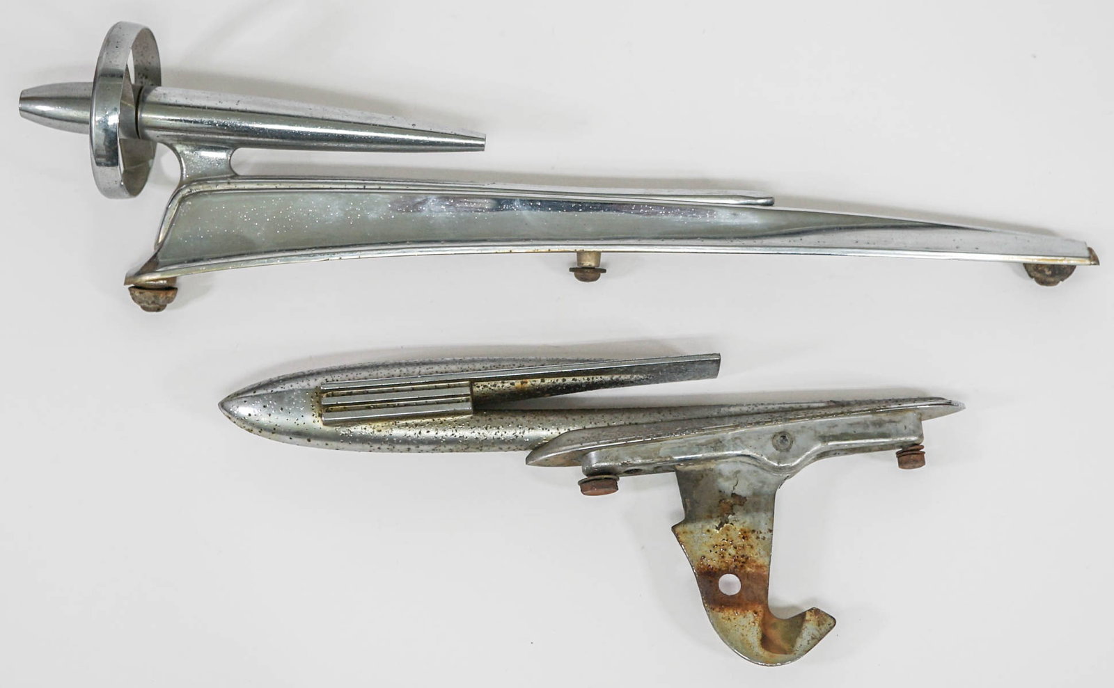 Vintage (2) Hood Ornaments-Buick Gun Sight Rocket: Two (2) vintage automobile hood ornaments include: 19 inch long 1949-1951 Buick - Gun Sight Roadmaster Super Rocket Chrome Trim V (chrome is pitted); and a 12 inch rocket shape (heavily pitted). If lo