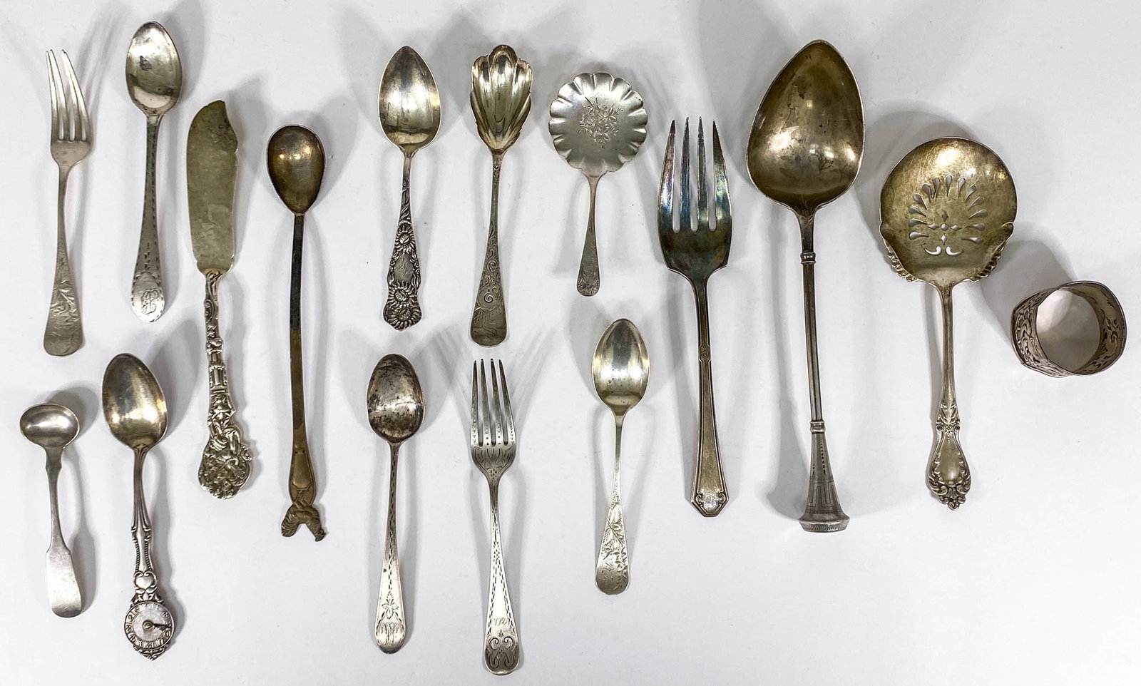 Coin and Sterling (16) Items 456g: Coin and Sterling items. Makers include: Christian Wiltburger, B. C. Hopper; J. C. Watts and Co., Wilson Spoon Co., Hamilton and Diesinger; and others. If lot is absent of a condition report one may b