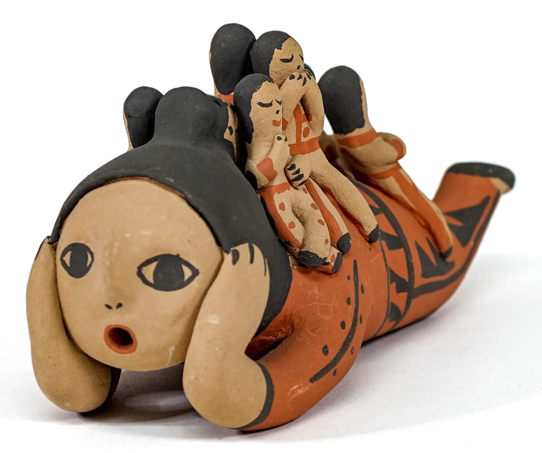 Toya Jemez Pueblo Clay Storyteller Figure: Toya signed Native American Jemez Pueblo clay storyteller figure measures 9 in. long x 4 in. high x 3.5 in. wide. Wear to underside at knees and elbows. No evidence of cracks or repairs. If lot is abs