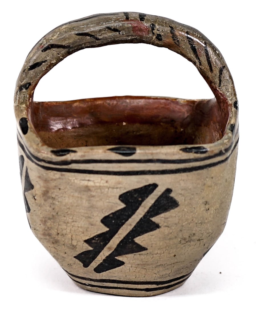 San Ildefonso Pueblo Pottery 4IN Basket AS-IS: San Ildefonso Pueblo pottery basket measures 4 in. high x 3 in. x 3 in. across top. AS-IS with cracks and wear on handle. If lot is absent of a condition report one may be requested via email. Conditi