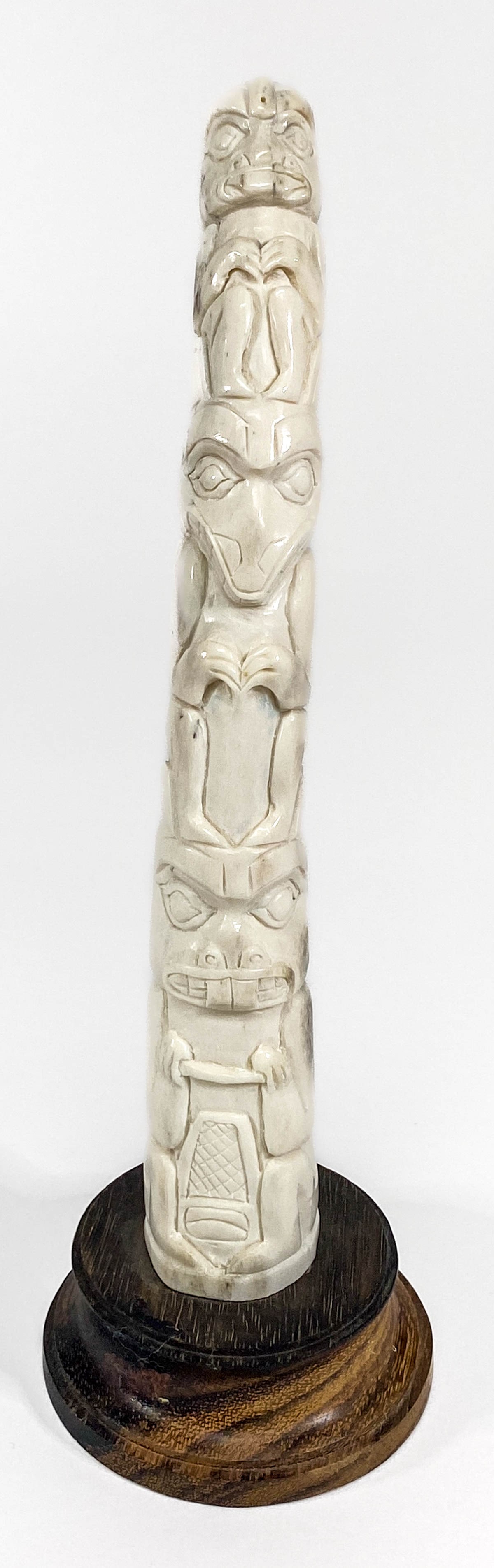 Northwest Coast Antler Carved Totem: Northwest Coast Antler Carved Totem. Measures 7 inches height (not accounting for the base) x 1.125 x 1.125 inches and stands 8 inches tall total. No evidence of cracks, chips or repairs. If lot is ab