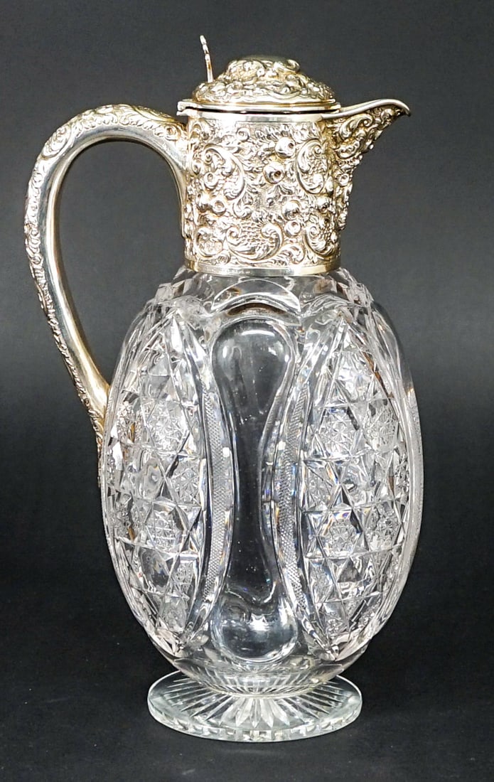 Drew & Sons Sterling Claret Jug 1898 Silver Mount: Drew and Sons (Samuel Summers Drew and Ernest Drew), Picadilly Circus, London 1898 cut glass claret jug with repousse sterling mount measures 10.25 in. tall x 6 in. at widest point. No evident cracks