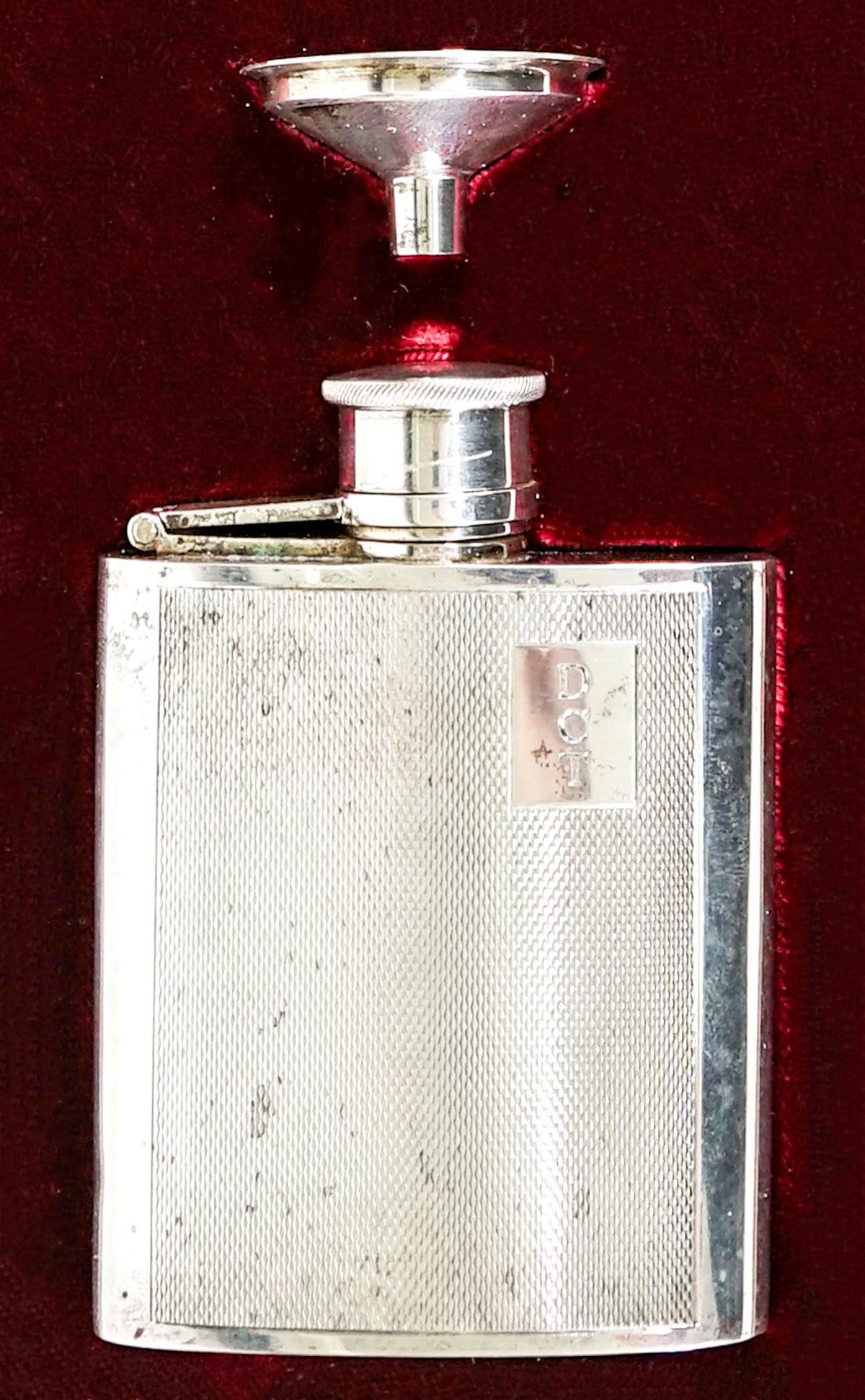 Asprey London Silver Flask w/ Funnel 138g: Asprey London silver flask with funnel in original case. Date mark 1996. Monogrammed. Weighs 138 grams. Small dink at edge underside. Flask measures 3.625 in. tall x 2.75 in. wide. If lot is absent of