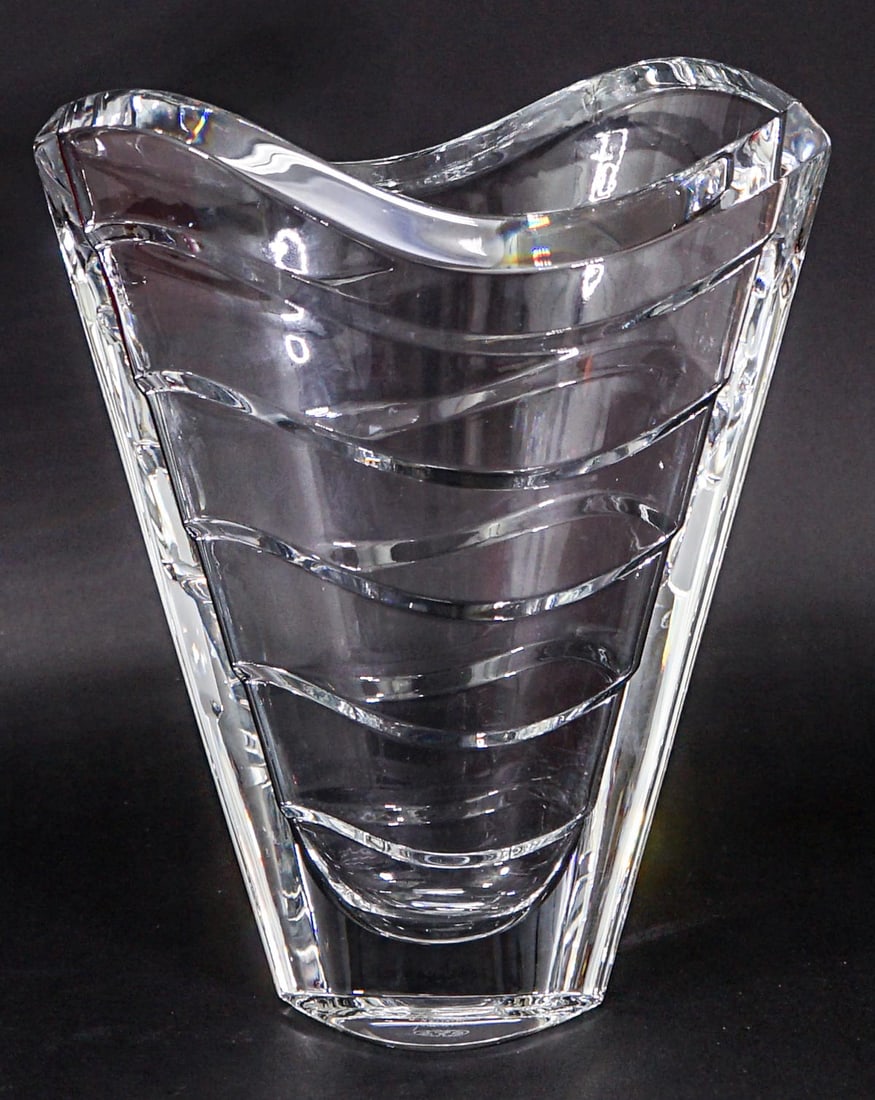 Baccarat Wave Vase 2104168 MIB: Baccarat vase Made in France with original box measures 11 in. tall x 9.5 in. wide. No evident cracks or repair. Box lid has split at seam, front right. If lot is absent of a condition report one may 