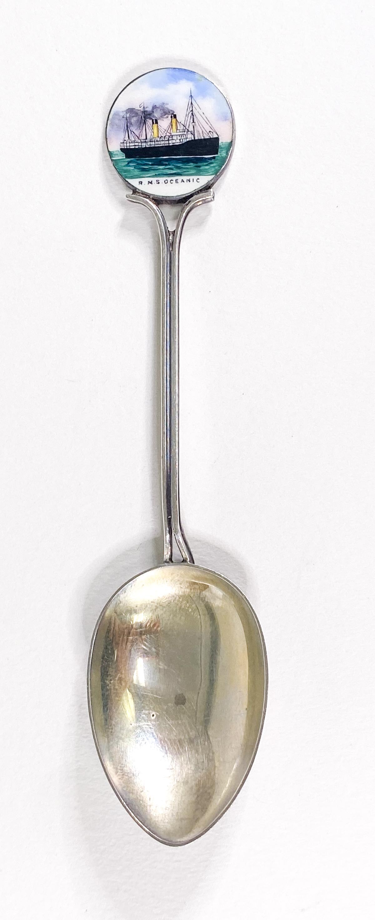 R.M.S. Oceanic Enamel Souvenir Spoon: R.M.S. Oceanic Enamel Souvenir Spoon. Measures 4.375 inches length, enamel pictorial of the ship measures .75 inches. Spoon is manufactured by Emanuel of Southhampton. If lot is absent of a condition 