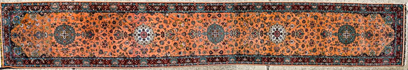 Very Fine Long Runner Rug: Very Fine Long Runner Rug. Measures 16 feet 8 inches x 2 feet 6.75 inches. There are numerous scattered stains. This item requires the use of an outside shipper. If lot is absent of a condition report