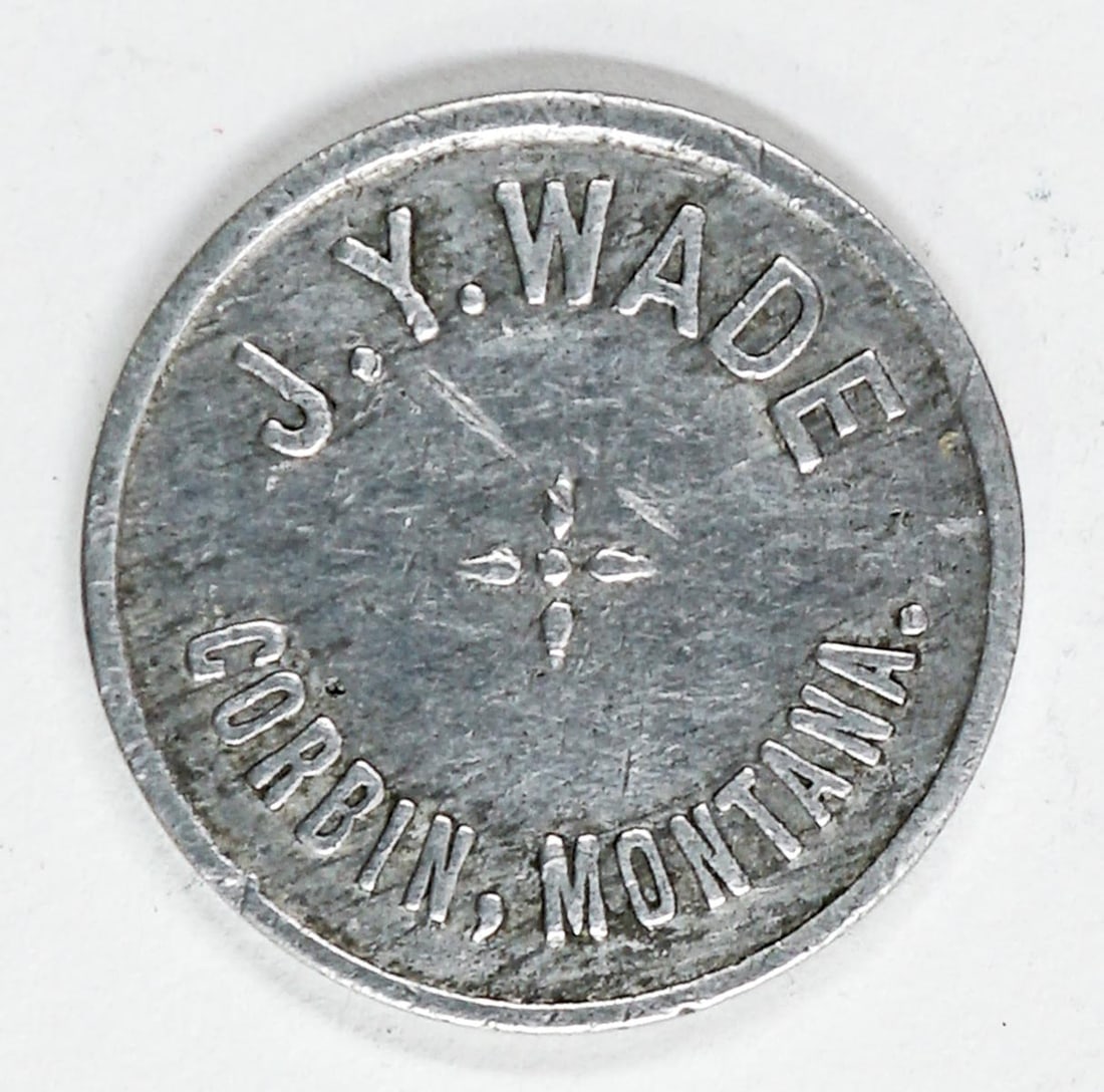 J.Y. Wade, Corbin, Montana Token (Unlisted): J.Y. Wade, Corbin, Montana Token (Unlisted). Good for 1 Drink or Cigar. VG-EX/EX condition. Measures 21 mm. If lot is absent of a condition report one may be requested via email. Condition report is p
