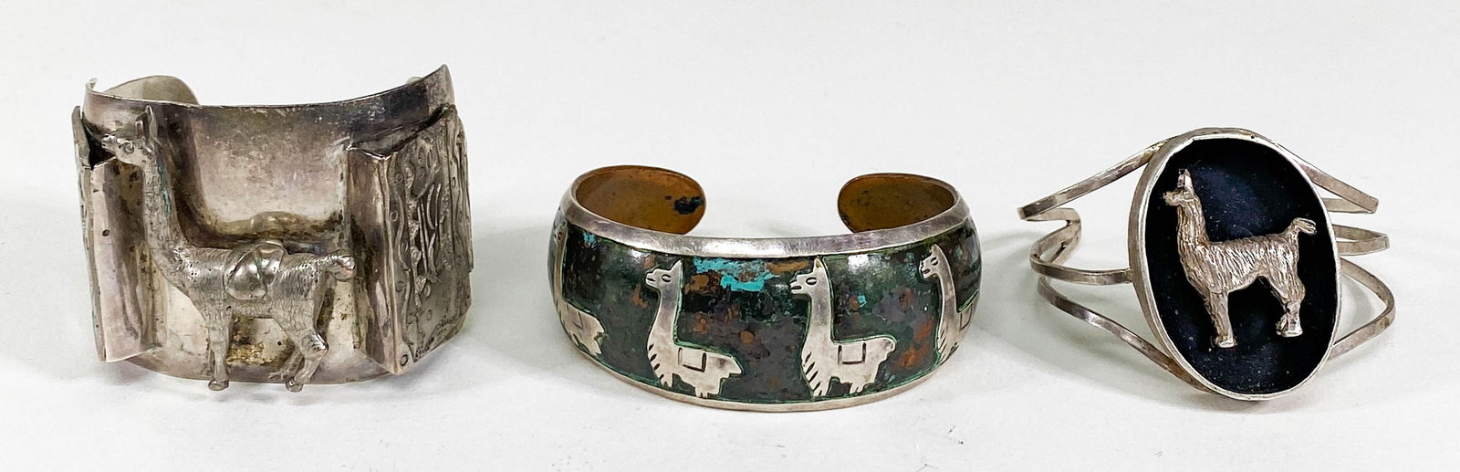Vintage Peruvian Cuff Bracelets: Vintage Peruvian Cuff Bracelets, two silver and one mixed metals. All are unmarked. They measure 1 inch, 1..5625 and 1.75 inches width. They weigh 138 grams total. If lot is absent of a condition repo