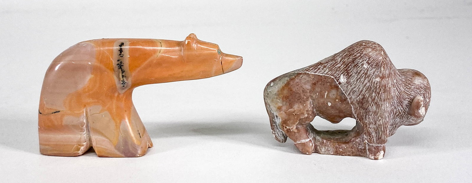 Native American Fetish / Carving [Buffalo]: Native American carvings include: Buffalo signed H. Becenti measures 2.75 in. long x 2 in. tall; Polar Bear measures 3.5 in. long x 2 in. tall. Note very light scarring, nicks along top and right ear.
