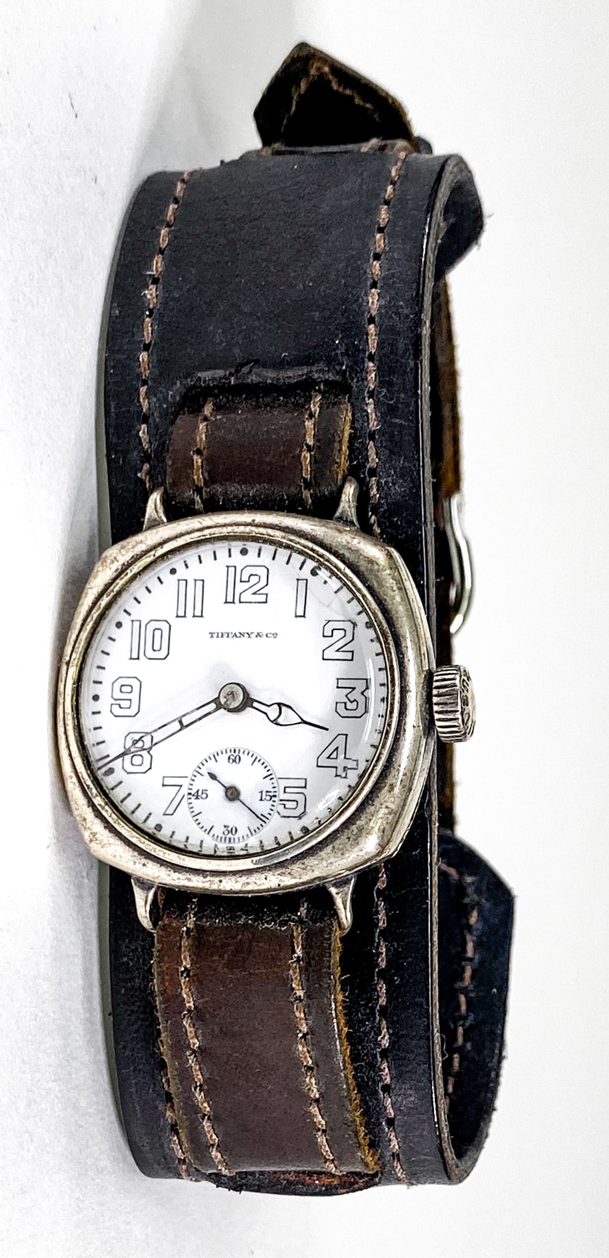 Tiffany & Co. Khaki WWI Trench Watch: Tiffany & Co. Khaki WWI Trench Watch. Stamped Khaki Reg. USA on crown. Dial measures 23 mm, total diameter 28 mm. Not in running order. If lot is absent of a condition report one may be requested via 