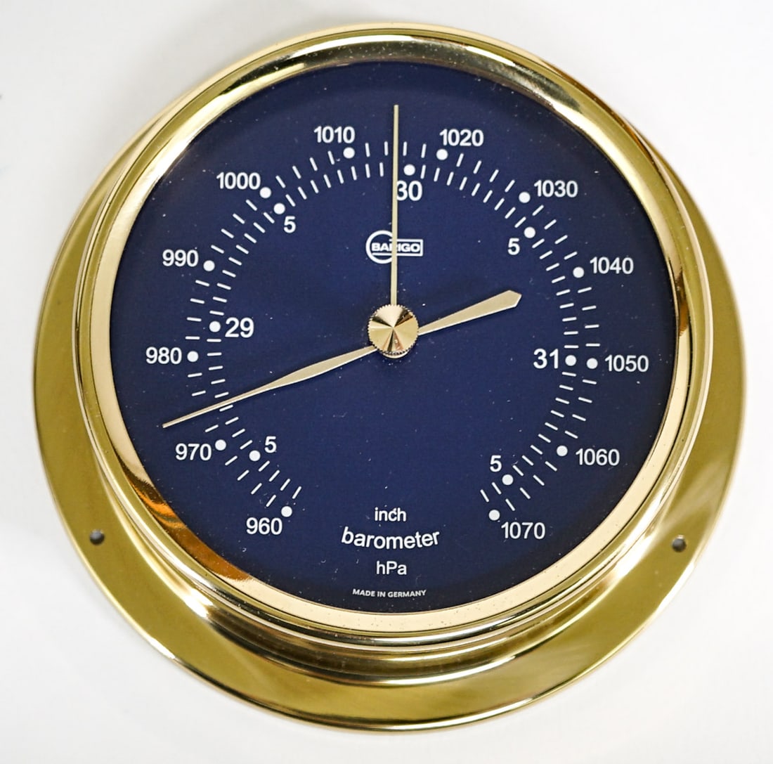 Barigo (Germany) Barometer MIB: Barigo Barometer with a dark blue face and white lettering. Polished brass. Measures 4 in. across face x 4.875 in. across base x 1.5 in. deep. Like new condition with original box. Not tested. If lot 