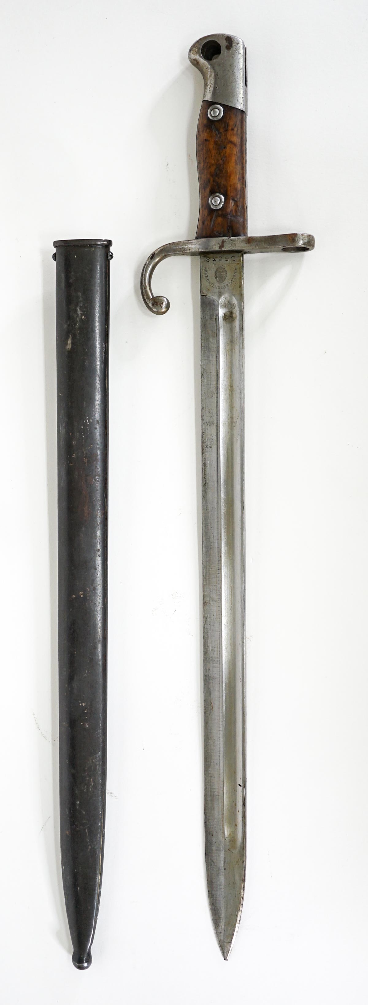 WWI Modelo Argentino Bayonet w/ Scabbard: WWI Modelo Argentino Bayonet with metal sheath. Serial #L6538 is on the blade. Measures 21.5 in. H x 4 in. W x 1.25 in. D. The absence of a condition report does not imply that the lot is in perfect c