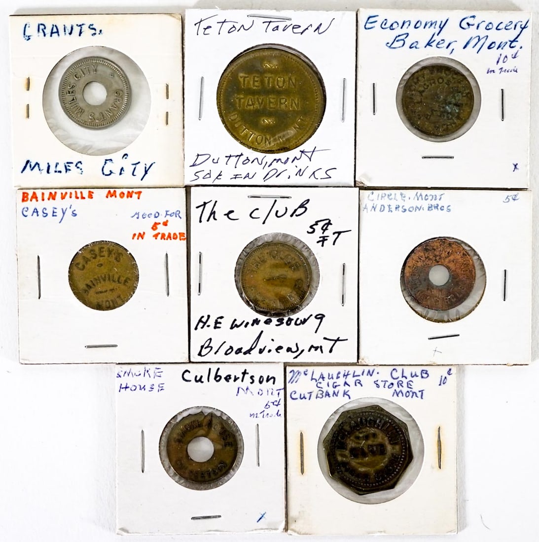 Montana (8) Trade Tokens: Eight (8) Montana trade tokens. Culbertson, Baker, Broadview, Dutton, Cut Bank, Bainville, Circle, Miles City. Lot measures 2 in. H x 2 in. W x .75 in. D. The absence of a condition report does not im