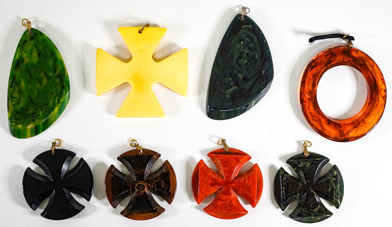 (8) Large Bakelite Pendants: A group of eight large Bakelite pendants (tested positive for Bakelite). They measures 2 x 2 inches to 3 x 1.75 inches. They measure 5 x 3 x 1 inches combined. Due to the volume of this estate collect